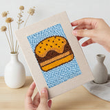 Hand holding a finished Blue Cherry Cupcake mini canvas