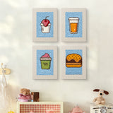 The four Blue Cherry Cupcake mini canvases on a wall above a shelf