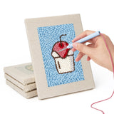 Hand punching one of the Blue Cherry Cupcake mini canvases