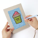 Punching a Blue Cherry Cupcake mini canvas with the punch needle