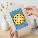 Hand holding a finished Blue Donut Duo mini canvas