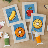 The four finished Blue Donut Duo mini canvases laid out on a table