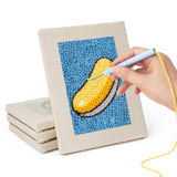 Hand punching one of the Blue Donut Duo mini canvases