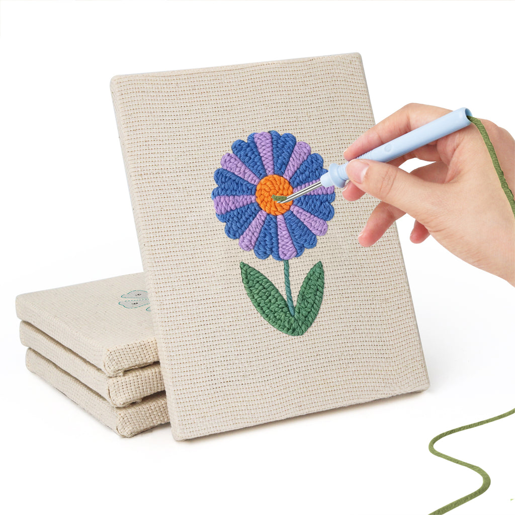 Hand punching one of the Blue Garden Blooms mini canvases