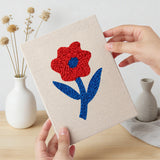 Hand holding a finished Blue Leaf Flowers mini canvas