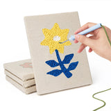 Hand punching one of the Blue Leaf Flowers mini canvases