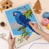 Punching the Blue Macaw design with the punch needle
