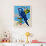 Finished Blue Macaw punch needle canvas on a wall