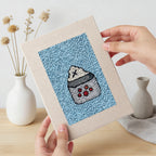 Hand holding a finished Blue Mug Morning mini canvas