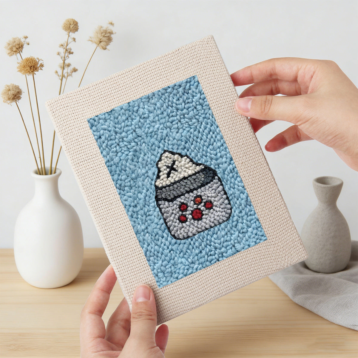 Hand holding a finished Blue Mug Morning mini canvas