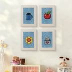 The four Blue Mug Morning mini canvases on a wall above a shelf