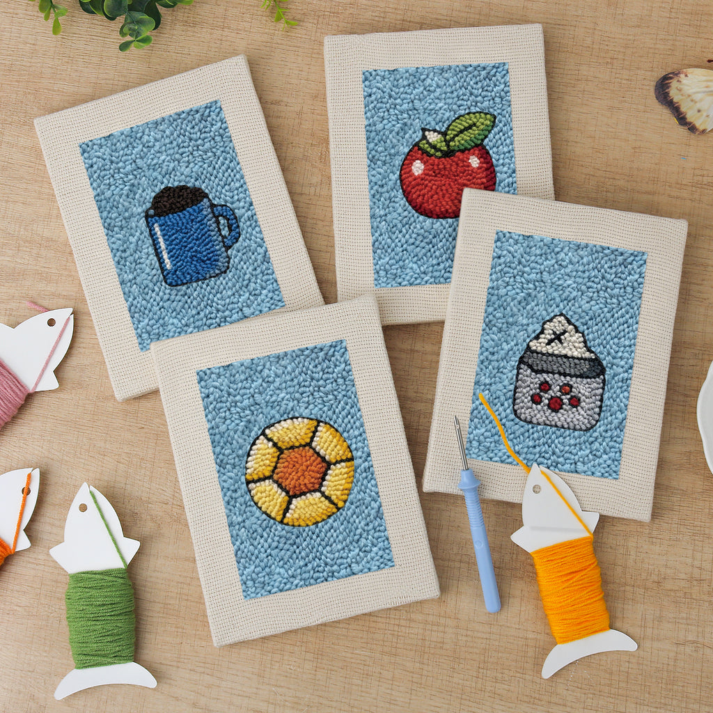 The four finished Blue Mug Morning mini canvases laid out on a table
