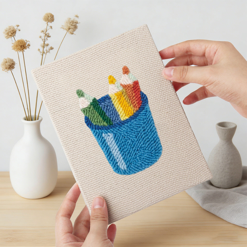 Hand holding a finished Blue Pencil Pot mini canvas