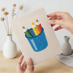 Hand holding a finished Blue Pencil Pot mini canvas