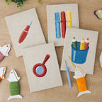 The four finished Blue Pencil Pot mini canvases laid out on a table