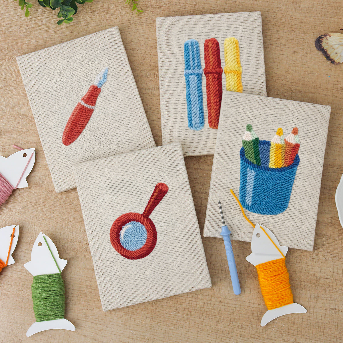The four finished Blue Pencil Pot mini canvases laid out on a table