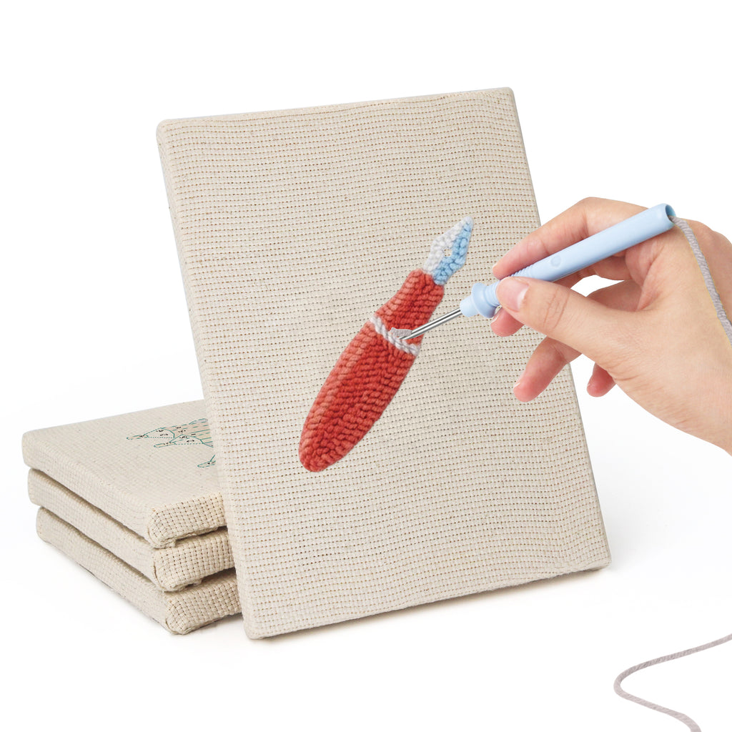 Hand punching one of the Blue Pencil Pot mini canvases