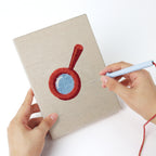 Punching a Blue Pencil Pot mini canvas with the punch needle