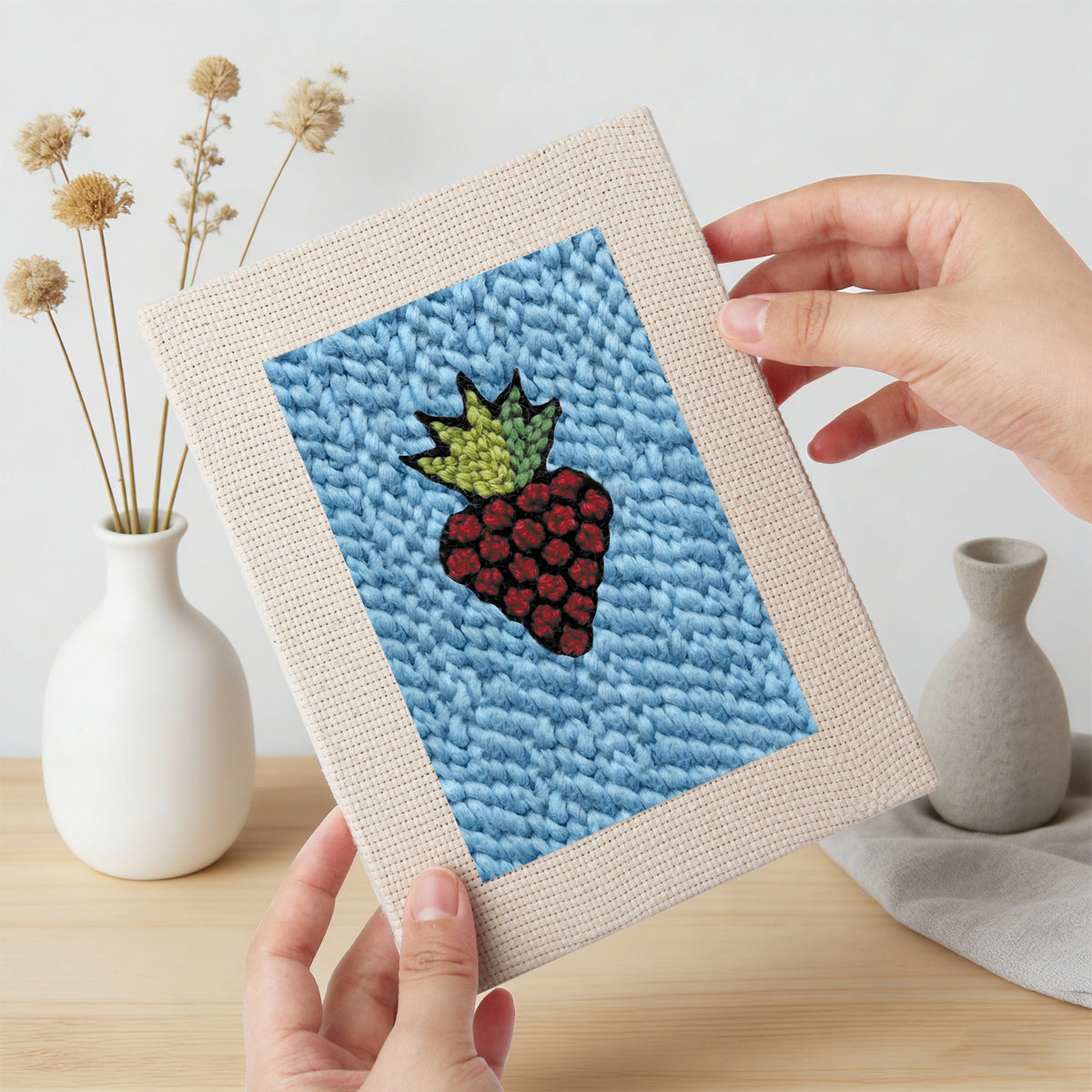 Hand holding a finished Blue Plate Snacks mini canvas