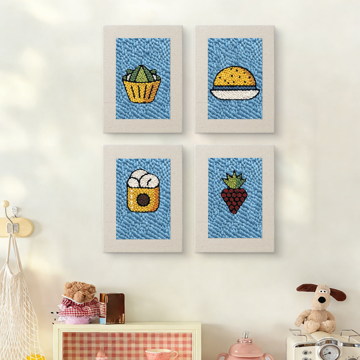 The four Blue Plate Snacks mini canvases on a wall above a shelf