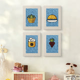 The four Blue Plate Snacks mini canvases on a wall above a shelf
