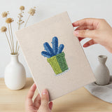 Hand holding a finished Blue Pot Cacti mini canvas
