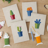 The four finished Blue Pot Cacti mini canvases laid out on a table