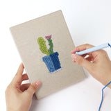 Punching a Blue Pot Cacti mini canvas with the punch needle