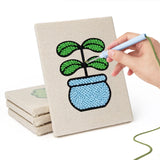 Hand punching one of the Blue Pot Greens mini canvases