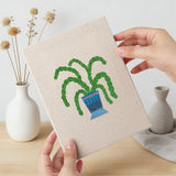 Hand holding a finished Blue Pot Houseplants mini canvas
