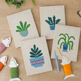 The four finished Blue Pot Houseplants mini canvases laid out on a table