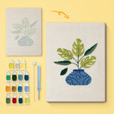 Blue Vase Leaves canvas before and after punching, with the threads and tools
