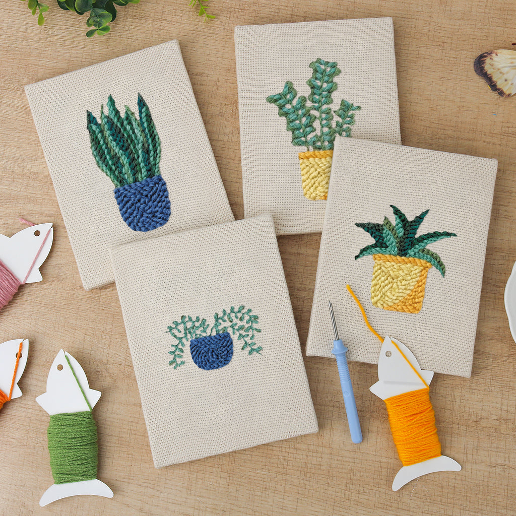 The four finished Blue Yellow Planters mini canvases laid out on a table