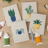 The four finished Blue Yellow Planters mini canvases laid out on a table