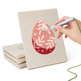 Hand punching one of the Blush Easter Eggs mini canvases