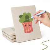 Hand punching one of the Blushing Coral Pots mini canvases