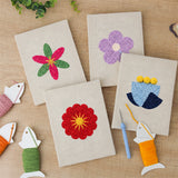 The four finished Bold Flower Heads mini canvases laid out on a table