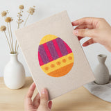 Hand holding a finished Bold Pattern Eggs mini canvas