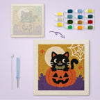 Bow Tie Cat on a Pumpkin canvas before and after punching, with the threads and tools