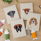 The four finished Boxer and Labrador mini canvases laid out on a table