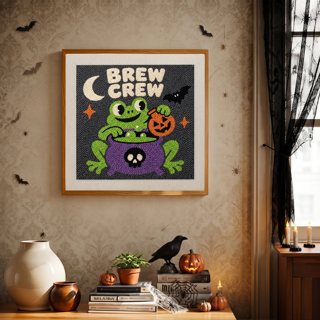 Finished Brew Crew Frog punch needle canvas on a wall
