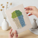 Hand holding a finished Bright Pot Cacti mini canvas