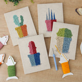 The four finished Bright Pot Cacti mini canvases laid out on a table