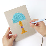 Punching a Bright Retro Lamps mini canvas with the punch needle