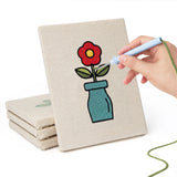 Hand punching one of the Bright Vase Plants mini canvases
