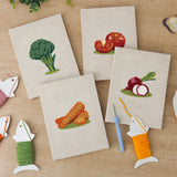 The four finished Broccoli Radish Bunch mini canvases laid out on a table