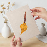 Hand holding a finished Broomstick and Hat mini canvas