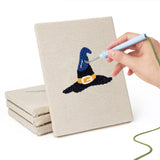 Hand punching one of the Broomstick and Hat mini canvases