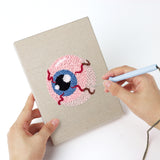 Punching a Broomstick and Hat mini canvas with the punch needle