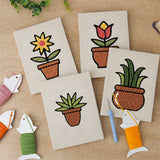 The four finished Brown Pot Blooms mini canvases laid out on a table